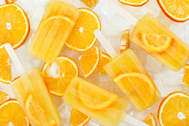 Fruit orange ice lolly and slices of orange - Photo, Image