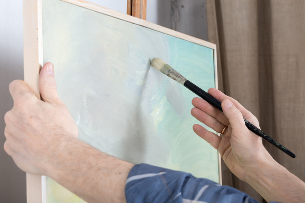 An artist painting in studio - Zdjęcie, obraz