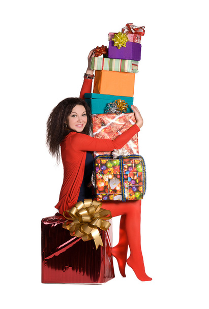 Beautiful girl holding a lot of boxes with gifts - Фото, зображення