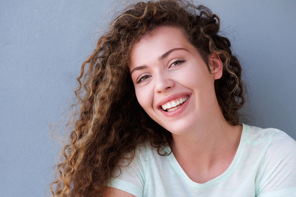 Smiling teen girl on gray background - Photo, Image