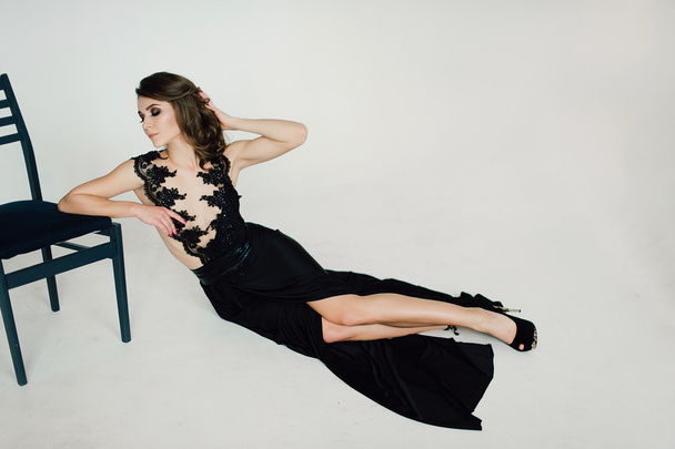 Individuality. Thoughtful Elegant Lady in Black Prom Evening Dress. Studio retouched photo. - 写真・画像
