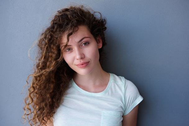 Pensive teen girl standing with curly hair  - Photo, Image