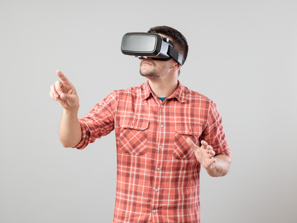Man with virtual reality glasses showing gesture - Φωτογραφία, εικόνα
