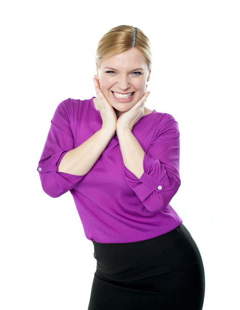 Excited woman posing with hands on chin - Foto, Bild