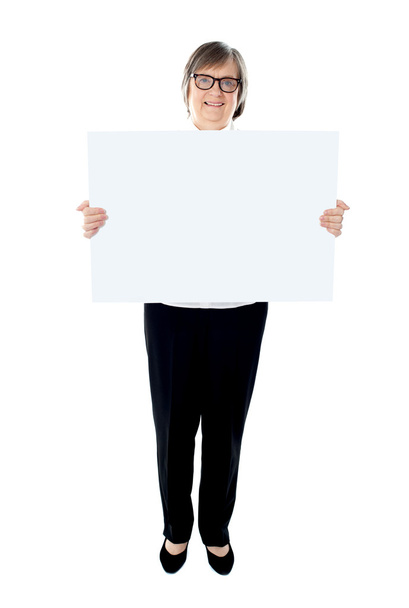 Senior female executive showing advertising board - Zdjęcie, obraz