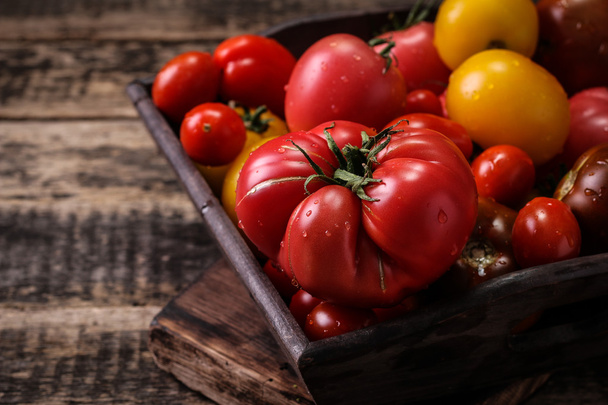 Colorful tomatoes, red tomatoes, yellow tomatoes, orange tomatoes, green tomatoes. Tomatoes background. vintage wooden background - Valokuva, kuva