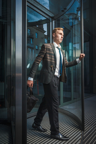 Young handsome successful stylish businessman near modern office - Foto, Imagen
