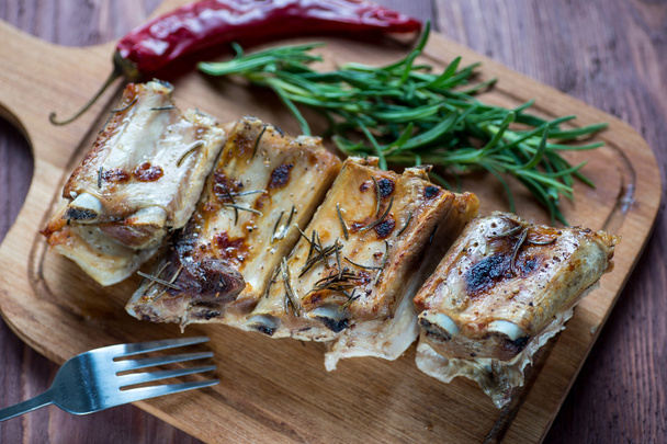 Roasted sliced barbecue pork ribs, focus on sliced meat - Фото, изображение