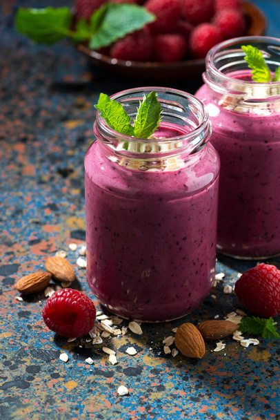 berry smoothie in a bottle on a dark background, closeup  - Photo, image