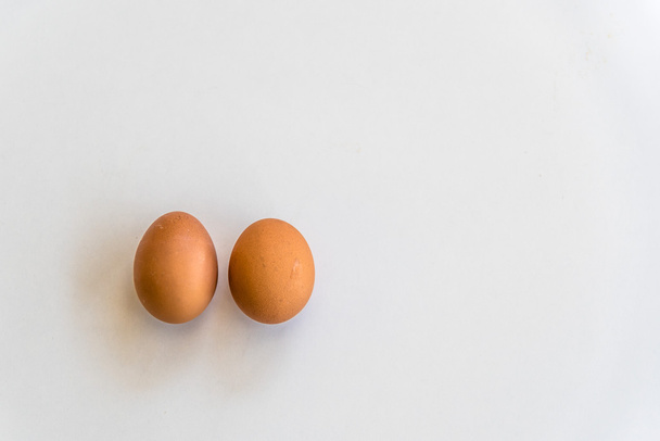 Two eggs on white table - 写真・画像