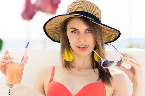 Young woman in swimwear is posing on beach - Foto, immagini