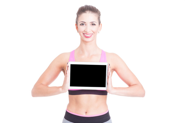 Sport female trainer holding black screen tablet - Fotoğraf, Görsel