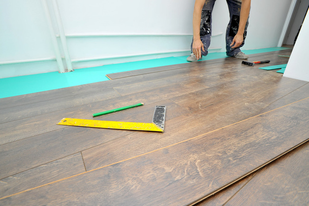 Carpenter doing laminate floor work - Photo, Image