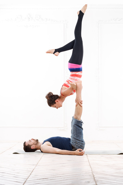 Beautiful Young Couple Practicing Acro-Yoga - Zdjęcie, obraz