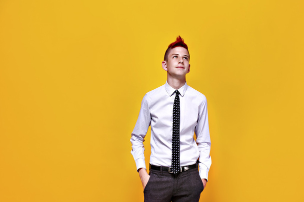 Fashionable teen with red mohawk looking away - Foto, immagini