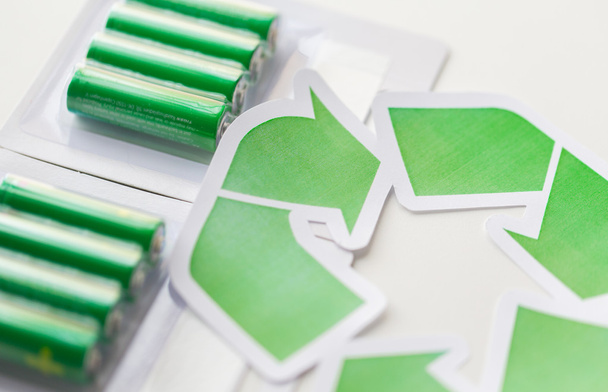 close up of batteries and green recycling symbol - Valokuva, kuva