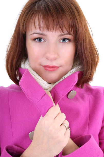 Cute woman in pink coat over white background - Photo, image