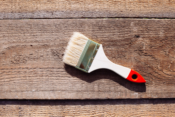 Paint brush on wooden table. House renovation.  - Fotó, kép