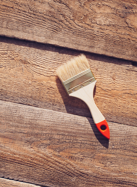 Paint brush on wooden table. House renovation.  - Foto, afbeelding