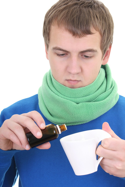 Молодий чоловік в синьому кольорі з ліками і чашкою
 - Фото, зображення