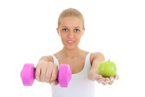 Young woman with dumbbell and apple - Fotoğraf, Görsel