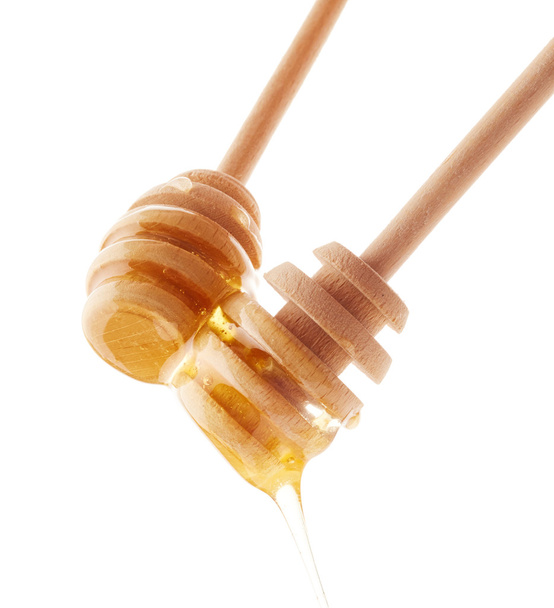 Miel que gotea de bañadores de miel de madera
  - Foto, imagen