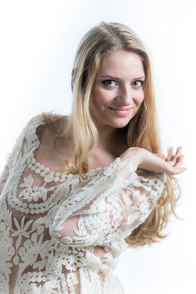 Beautiful Russian blonde girl on a white background in a white translucent blouse - Fotoğraf, Görsel