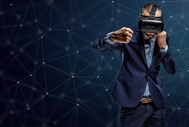 Fighter in a suit with virtual reality glasses - Fotoğraf, Görsel