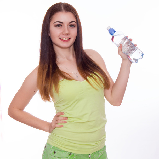 Female fitness model holding a water bottle - Foto, afbeelding