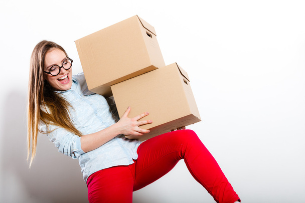 Happy woman moving into house carrying boxes. - Valokuva, kuva