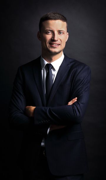 Close  up portrait of a business man on black background - Photo, Image
