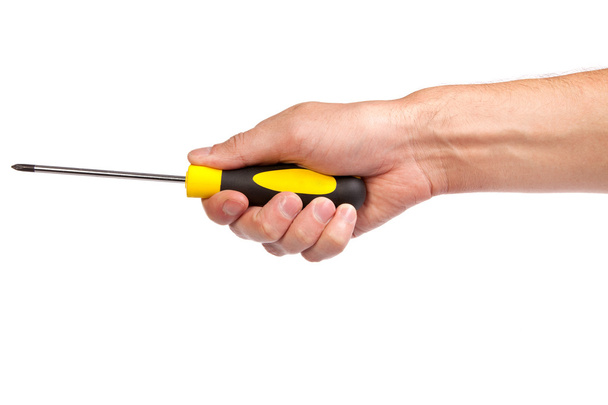 Hand holding a yellow and black screwdriver - 写真・画像