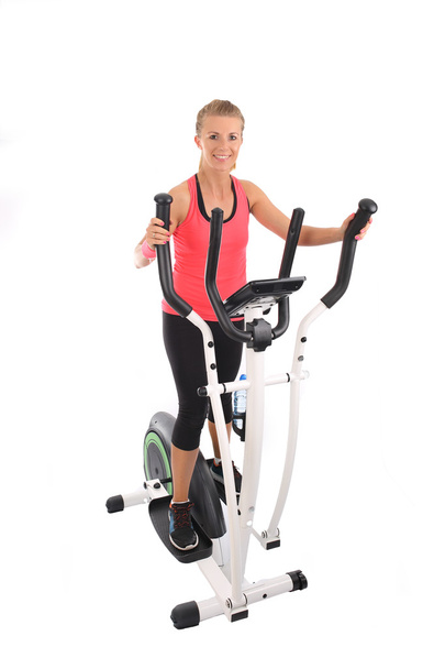 Young girl practicing on the cross trainer - Photo, Image