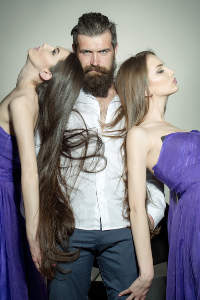 Bearded man and two women - Photo, Image