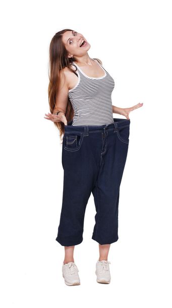 Mujer joven feliz de los resultados de dieta de pérdida de peso, aislado
 - Foto, Imagen