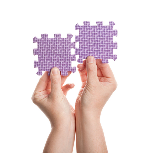 Hands holding foam puzzle pieces - Photo, Image