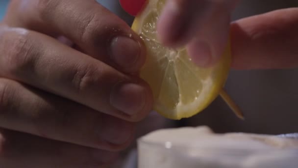 Adding a lemon and cherry in a cocktail - Felvétel, videó