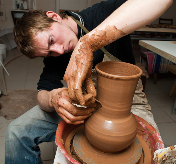Potter, creating an earthen jar on the circle - Photo, Image