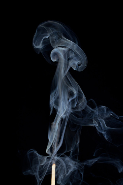 Match in the smoke - Фото, изображение
