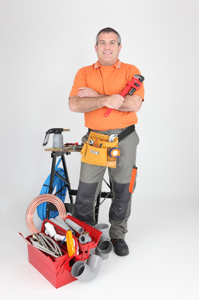 Studio shot of a plumber with tools of the trade - Photo, image