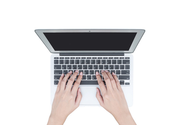 Closeup woman hand typing on keyboard at the gray notebook computer isolated on white background - Photo, Image