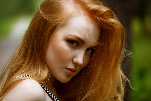 Portrait of a redhead girl looking tempting - Photo, Image