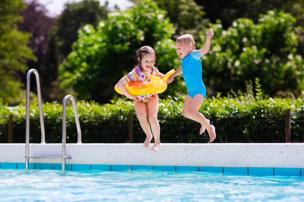 Kids jumping into swimming pool - Photo, Image