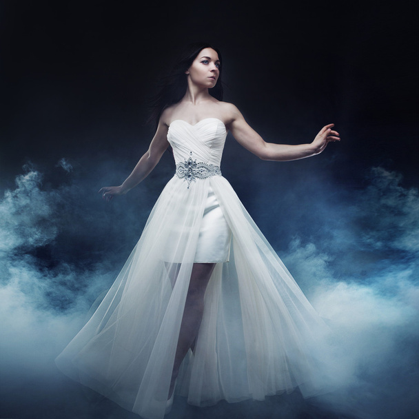 Beautiful sexy young woman. Portrait of girl in long white dress, mystical, mysterious style, dark background - Foto, immagini