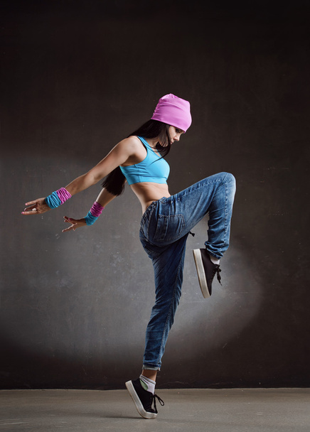 Young sexy woman dancer dancing on wall background - Fotografie, Obrázek