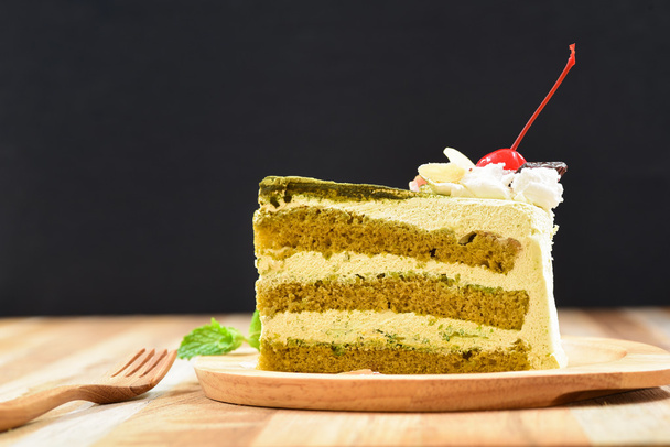green tea cake with a wooden fork - 写真・画像