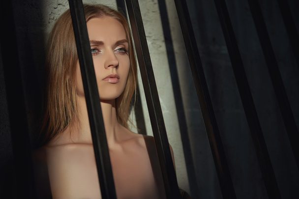 sad young woman in a cage - Foto, imagen