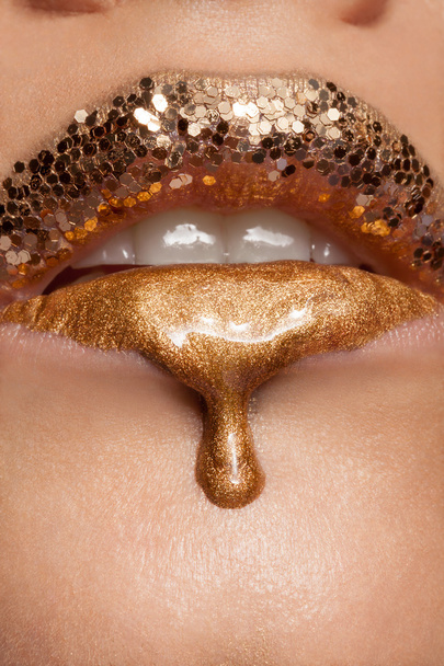 Creative make up of gold liquid lips - Photo, Image