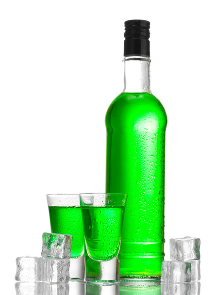 Bottle and glasses of absinthe with ice isolated on white - Photo, Image
