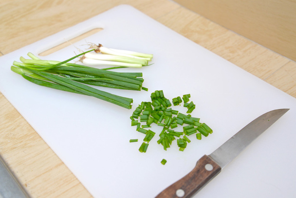 Cut spring onion on cutting board with knife, Thailand - Photo, Image